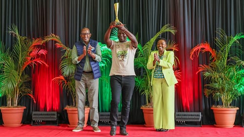 Collins receiving trophy from First Lady at State House